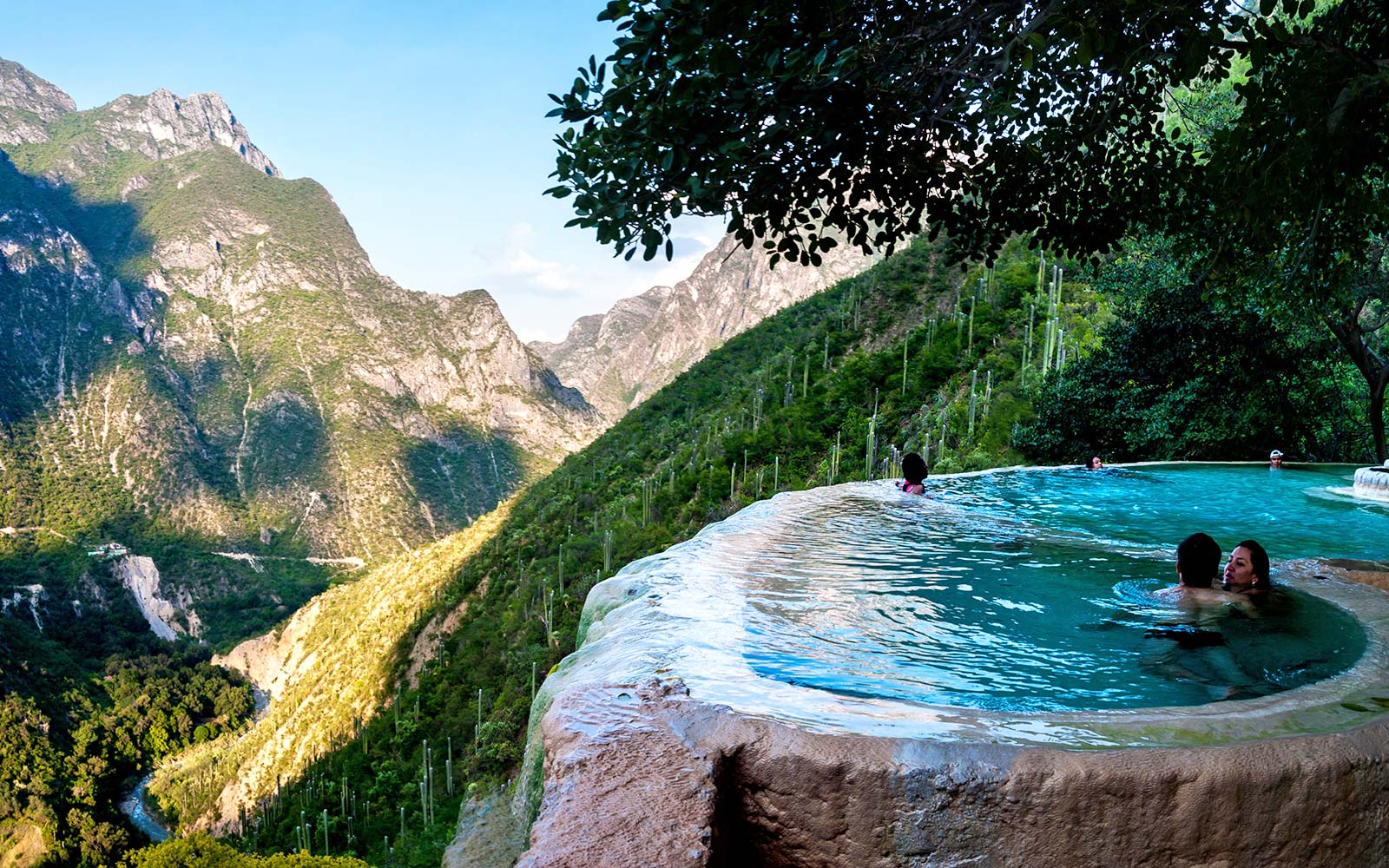 Relax in a Hot Spring Infinity Pool Overlooking Volcanic Mountains