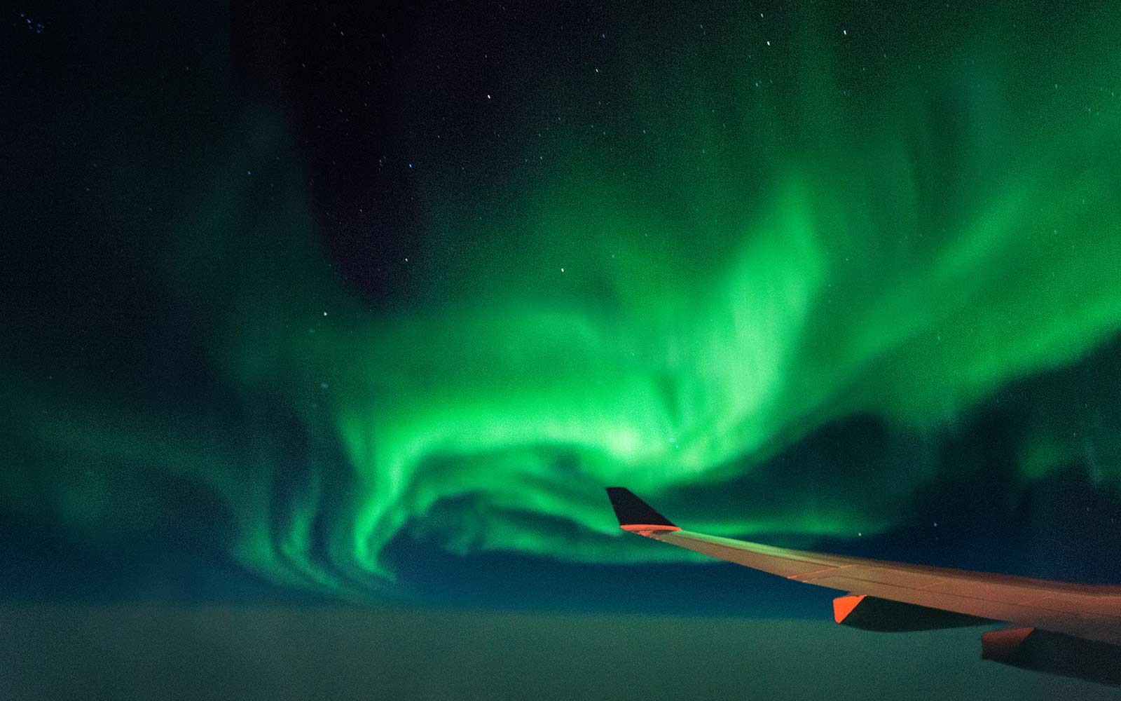 What the Northern Lights Look Like Through an Airplane Window