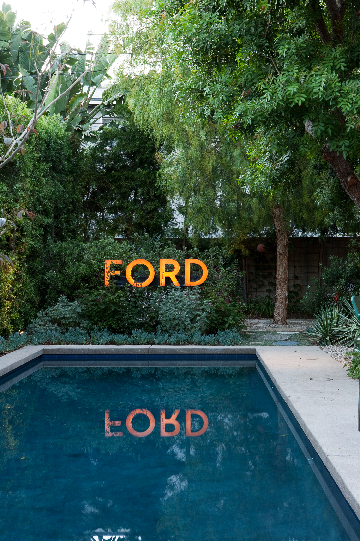 before-auto-dealership-sign-after-poolside-decor
