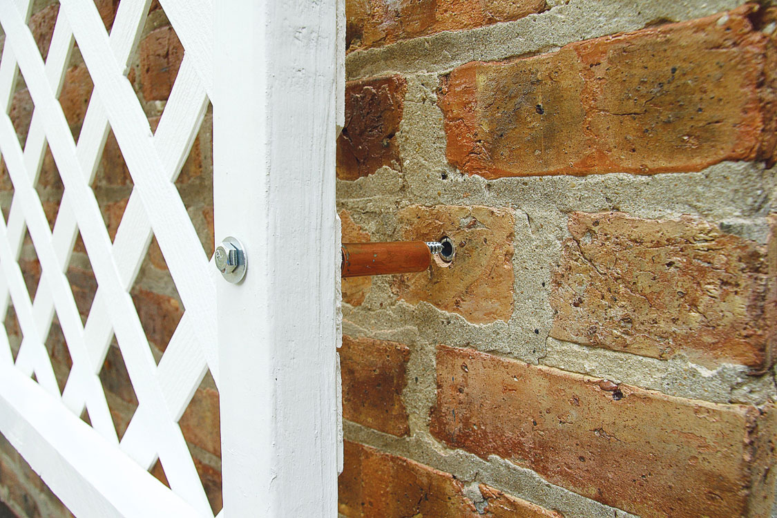 attach-the-panel-to-the-wall-using-pipe-standoffs