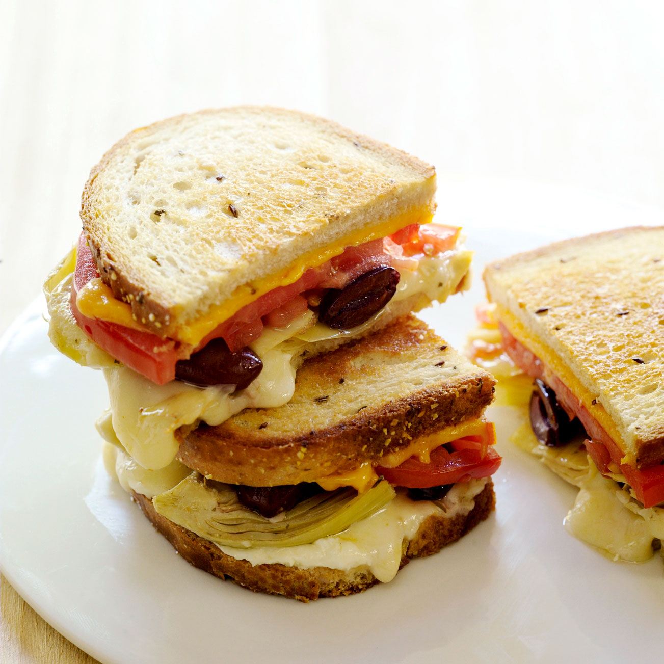 single-girls-grilled-cheese-sandwich-with-artichokes-tomato-and-black-olives