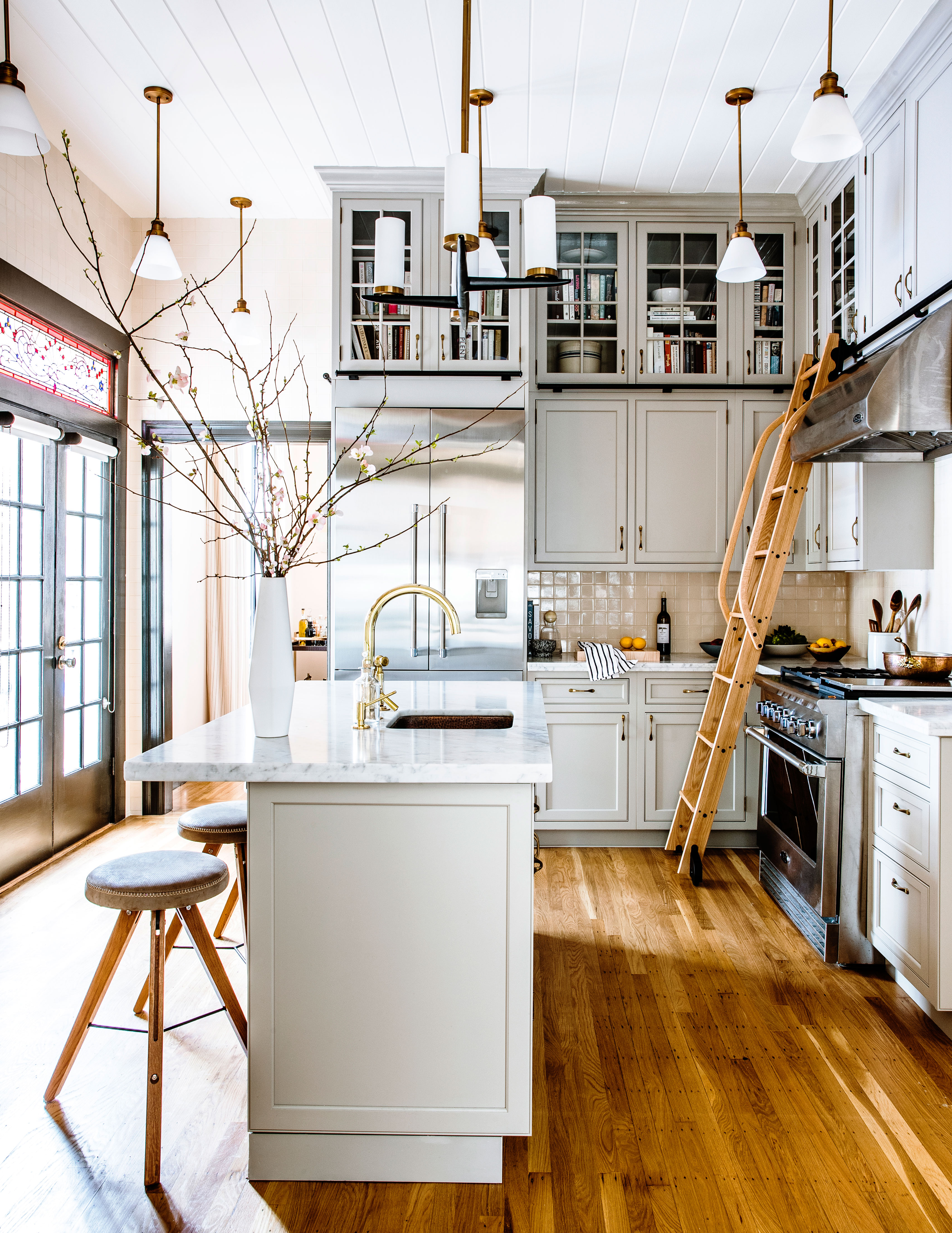 Green and marble tiles blend beautifully in this kitchen