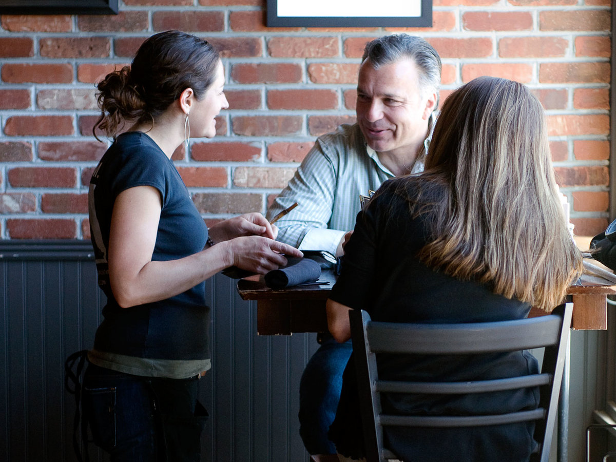 A waitress serves customers at Waterloo Records.