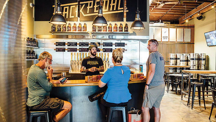 People inside Back Pedal Brewing