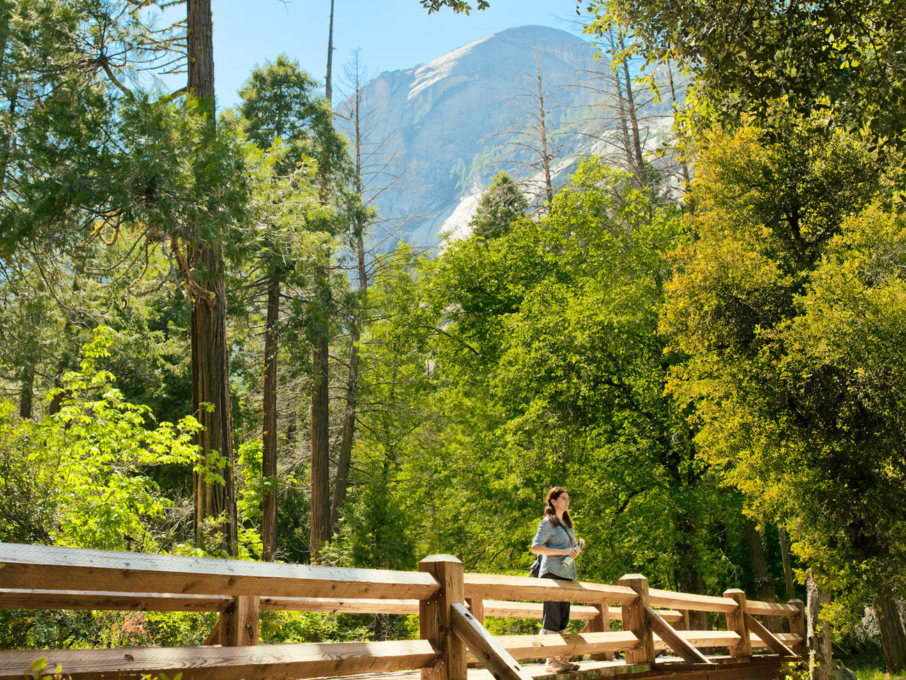 Person standing on wooden bridge on one of the best hike in Yosemite, Vernal Fall