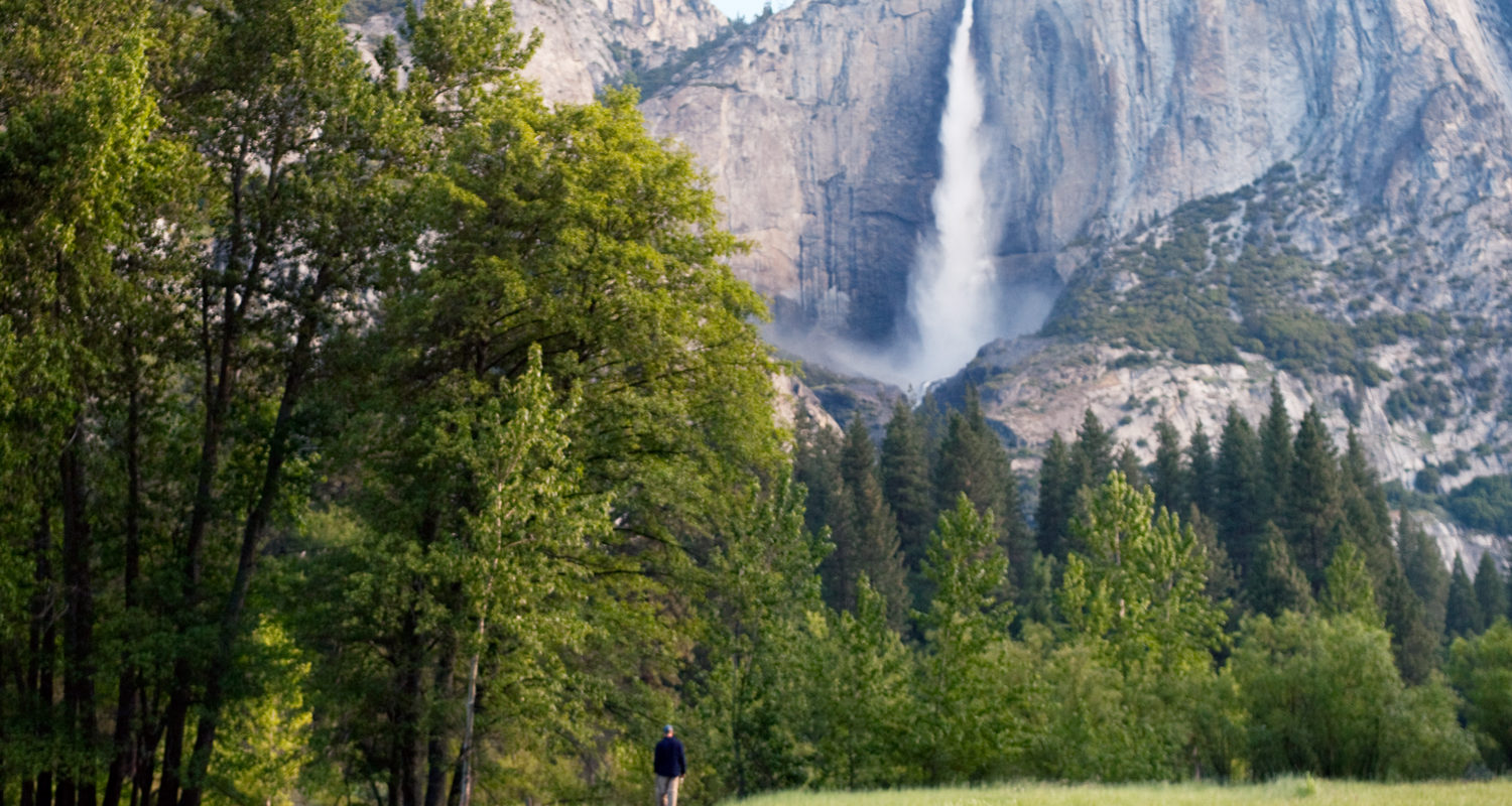 Man Walking on Path infront of Upper Yosemite Fall