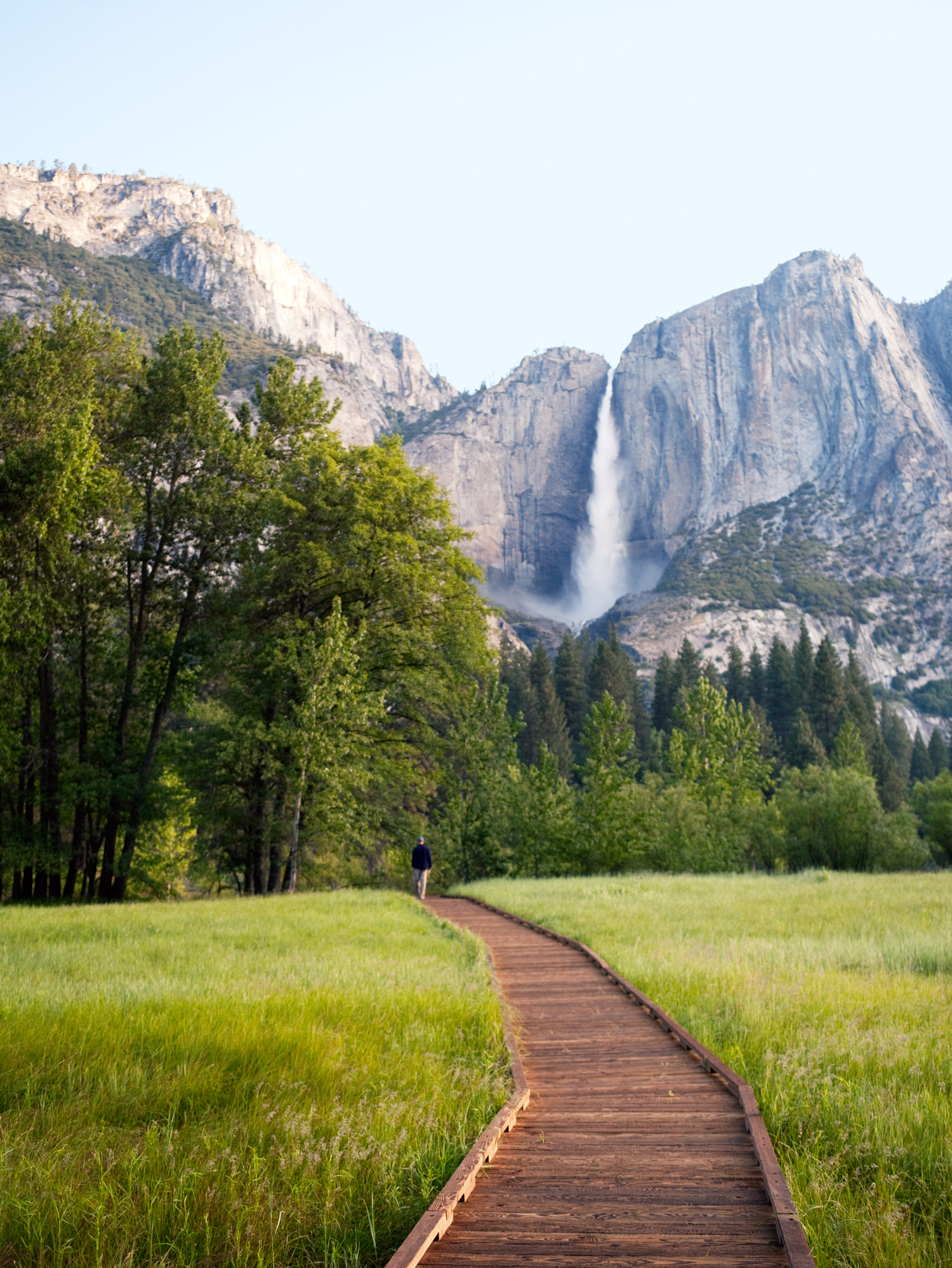Man Walking on Path infront of Upper Yosemite Fall